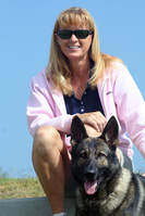 lady in pink jacket with german shepherd dog